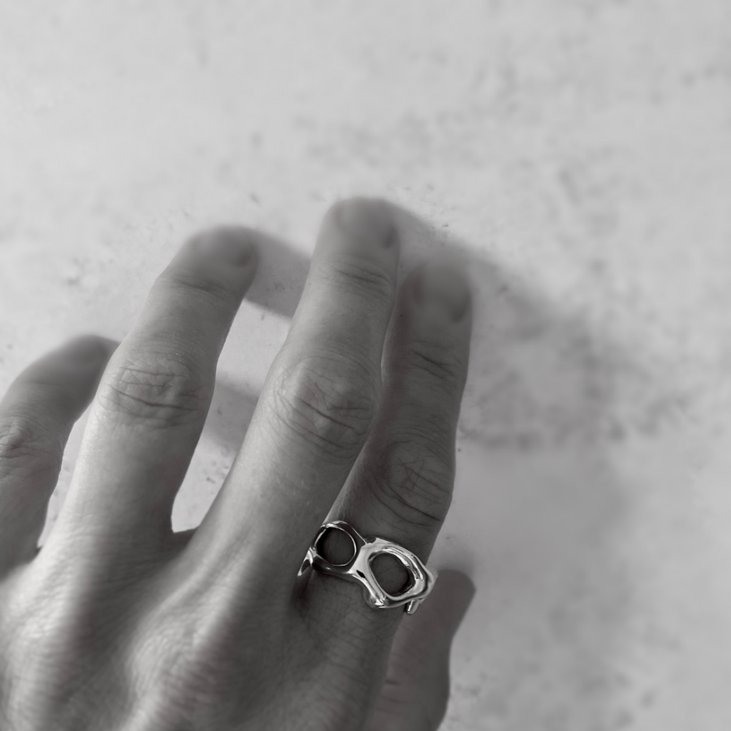 Species by the Thousands gold chain link ring on hand.