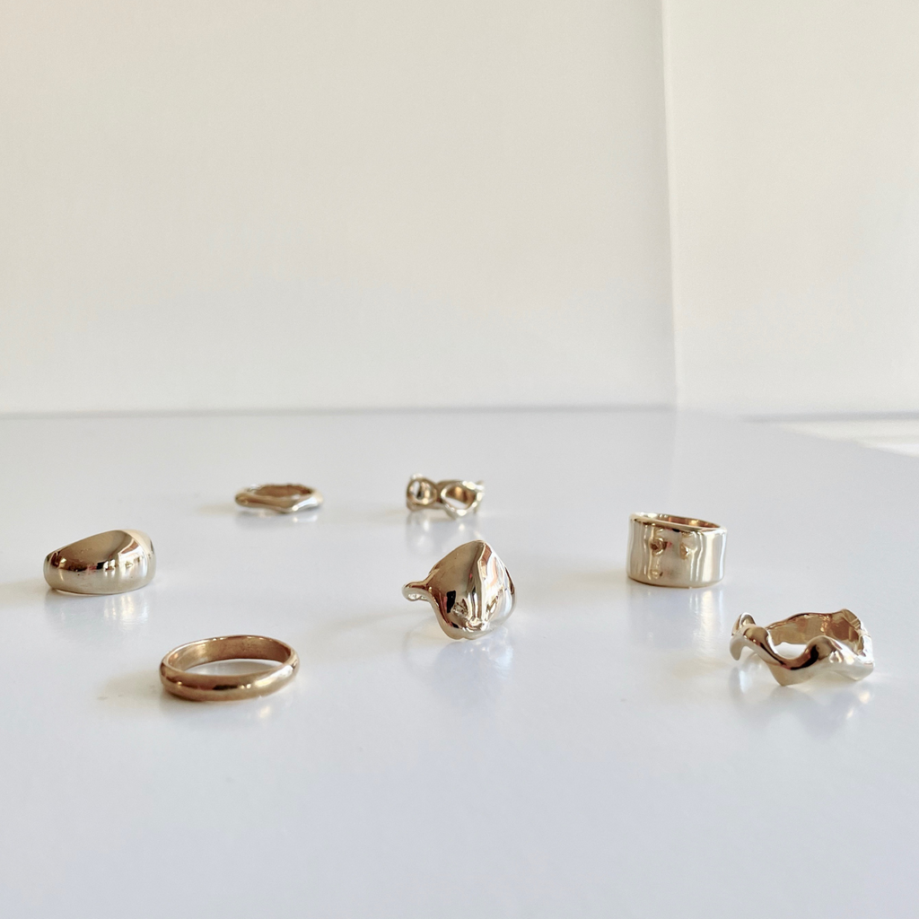 Species by the Thousands rings in brass.